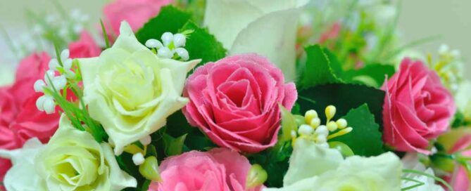 Beautiful flowers in basket on table.